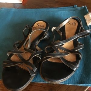 Black leather flat Sofft sandals. Straps have thin gold edges. Size 9.